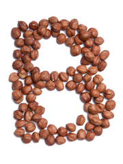 Letter B of the English alphabet from from hazelnut on a white isolated background. Food pattern made from nuts. Bright alphabet for shops.