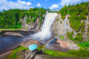 Naklejka premium Landscape View of Montmorency Falls and Magnificent Rainbow in Montmorency Falls Park, Quebec, Canada
