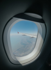 Aiplane windows view on bly sky and clouds from the cabin