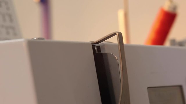 Close up of an industrial sewing machine in action stitching