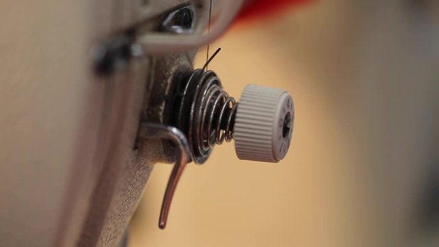 Extreme close up of an industrial sewing machine in action stitching
