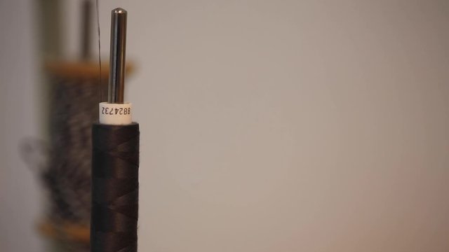 Extreme close up  the bobbins on an industrial sewing machine in action
