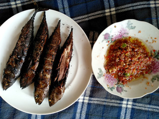 Traditional indonesian culinary food. sambal Matah Bali and Ikan Panggang or grilled fish with chili sauce. Ikan Panggang Indonesian Food that is simple and often made at home.