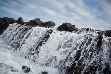 Waves crashing over rocks