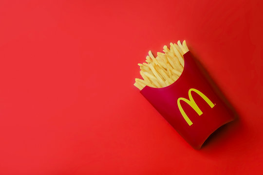 Bangkok ,Thailand - February 14 2019 : McDonald's French fries in the French fries box on red background. McDonald's Corporation is the world's largest fast food restaurant.