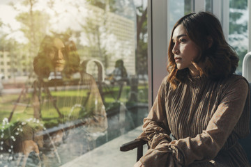 beautiful woman thinking and looking at window