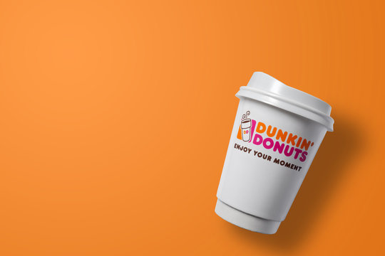 Bangkok ,Thailand - July 26 2019 : Dunkin donuts hot coffee cup on colourful background. Dunkin donuts is an American global doughnut company and coffee house chain.