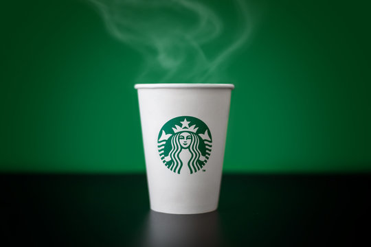 Bangkok ,Thailand - May 17 2019 : A cup of Starbucks coffee with logo isolated on Starbucks green background