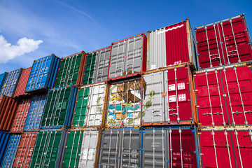 The national flag of Mexico on a large number of metal containers for storing goods 