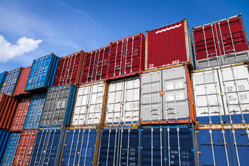 The national flag of Netherlands on a large number of metal containers for storing goods stacked in rows on top of each other. Conception of storage of goods by importers, exporters