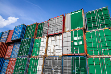 The national flag of Nigeria on a large number of metal containers for storing goods stacked in rows on top of each other. Conception of storage of goods by importers, exporters - obrazy, fototapety, plakaty