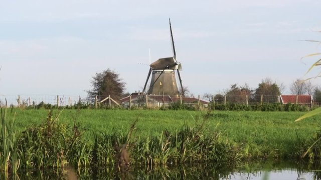 Dutch windmill with barns, grass and ditch in front, Oude Leede, the Netherlands