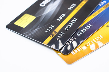 Close up of a set of cradit cards isolated on white background. Credit card lets cardholders borrow funds with which to pay for goods and services depend on the condition that cardholders pay back.