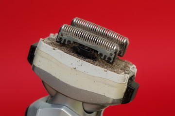 Closeup of dirty razors of foil electric shaver