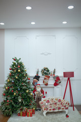 Mary christmas interior with new year pime tree decorated. Christmas red armchair and gifts. Santa...