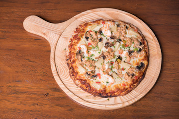 Tuna pizza with shrimp and pineapple, isolated, top view.