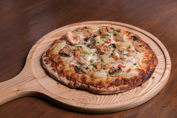 Tuna pizza with shrimp and pineapple, isolated, top view.