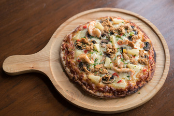 Tuna pizza with shrimp and pineapple, isolated, top view.