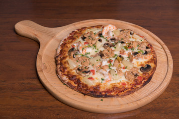 Tuna pizza with shrimp and pineapple, isolated, top view.