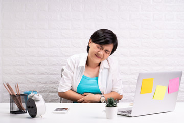 Woman has stomachache at office