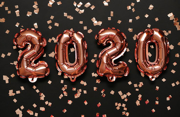 Shiny symbols 2020 on festive background.