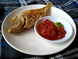 Traditional indonesian culinary food. sambal and Ikan Goreng or fried fish with chili sauce. Ikan Goreng Indonesian Food that is simple and often made at home. Indonesian Street Food.