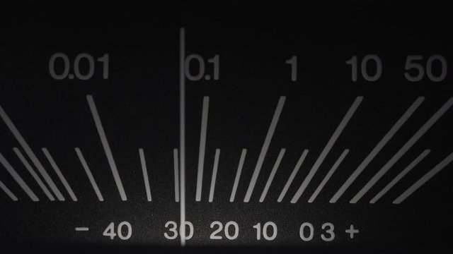 Old Reel Tape recorder close up. Shallow DOF of standard volume indicator scale. Vintage audio device analog VU meter. Recording studio.