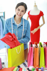 Fashion designer packing clothes for consumer..