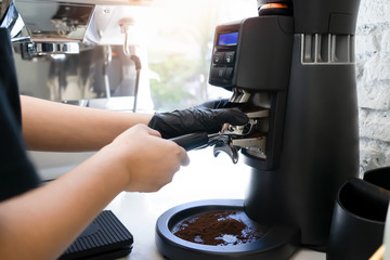 Barista make a coffee with coffee maker at cafe