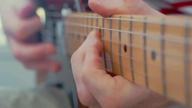 Close up playing electric guitar