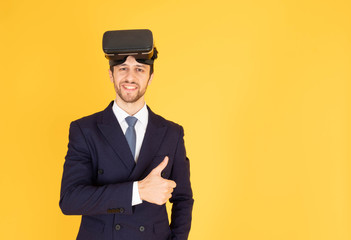 A man in a suit with a tie Handsome looking face with beard In the business man look Wearing a VR device on the other hand, holding his thumb up In the yellow background