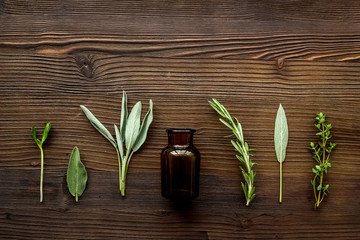 Herbal formulations for health care on dark wooden background top view pattern copy space