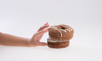 Donut or Donuts with hand on a background new.