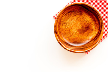 Wooden dishes. Bowl closeup on white background top view copy space