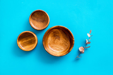Making wooden dishes. Empty bowls on blue background top view copy space
