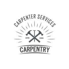 Black and white illustration of the logo of a carpentry workshop. Vector illustration of crossed hammers, nail and rays with text on a white background. Professional carpenter services.