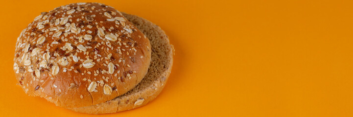 Rye bun empty isolated. American food classic rye round burger bread isolated on orange background....