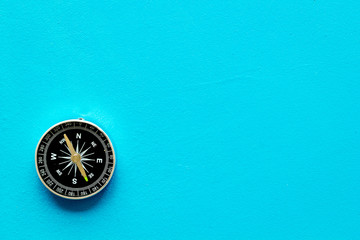 Compass - small and stylish - on blue background top view copy space