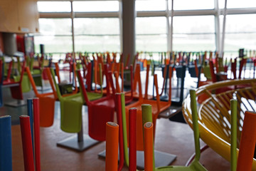 Colorful chairs were lifted on tables