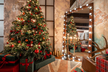 Winter home decor. Christmas in loft interior against brick wall. gifts under the tree. star lamp with light bulbs. Mirror garlands