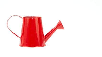 Red watering can on white background