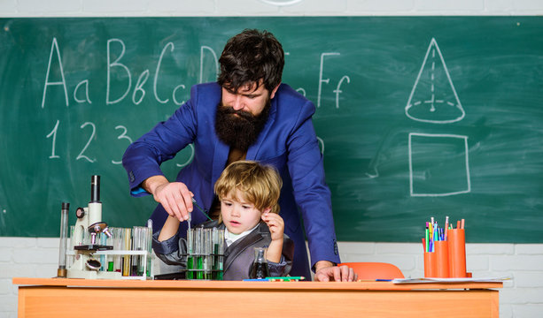 son and father at school. Wisdom. Back to school. Pharmacy and chemistry theme. solution in research laboratory. Genetic research. small boy with teacher man. You educate a man.