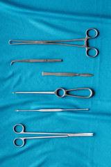 Instruments for plastic surgery on blue background flat lay pattern