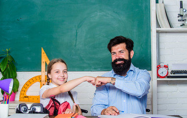 Discipline upbringing. Man bearded pedagogue study together with kid. Study is fun. School teacher and schoolgirl. Lesson is finished. Task successfully done. Homeschooling with father. Help study