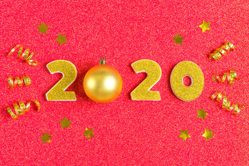 2020 numbers decorated with gold sequins, stars, ribbon, ball on shiny coral red background. Happy New Year, Merry Christmas concept Holiday card Flat lay Top view