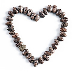 Heart made of chia seeds isolated on white background.