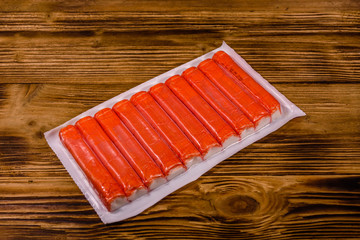 Vacuum pack of crab sticks on a wooden table © ihorbondarenko