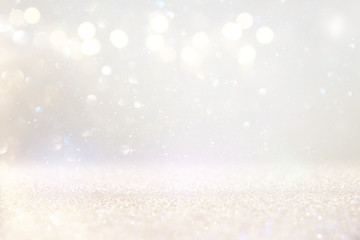 abstract background of glitter vintage lights . silver, gold and white. de-focused