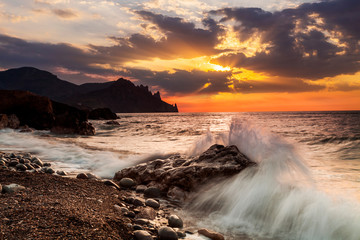 Dramatic sunset over the stormy sea. Summer vacation on tropical resort.