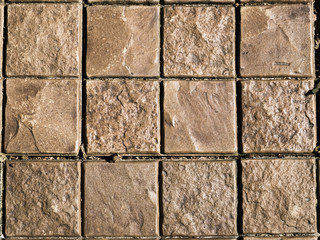 Square brown brick stone tiles on the floor